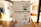 A hand holds up a white padded envelope with various labels and handwriting visible. The envelope has a large text that reads 'You've got mail' and is marked for air mail. The background is a softly lit room, partially blurred, with a hint of home decor and a large window letting in natural light.