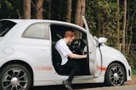 A driver checking the vehicle before a trip, ensuring safety and readiness.