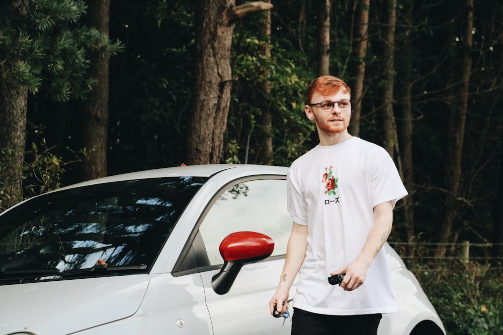 man standing beside car