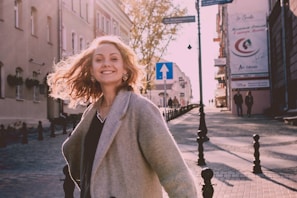 A confident person walking outdoors, hair catching the sunlight, embodying the main-character energy.