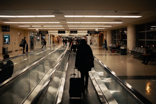 Traveller walking through the airport with luggage