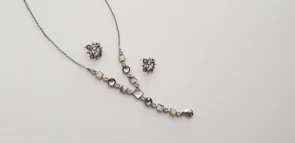 Elegant necklace with shimmering stones displayed against a clean white background.