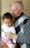 man carrying baby close-up photography