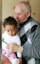 man carrying baby close-up photography