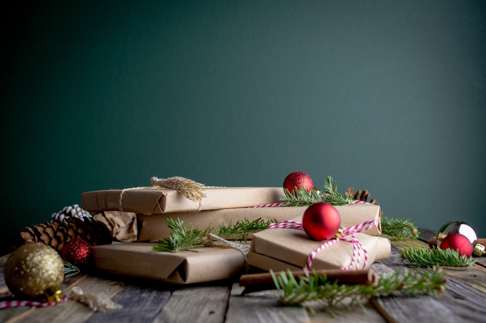 gift boxes with red baubles on top