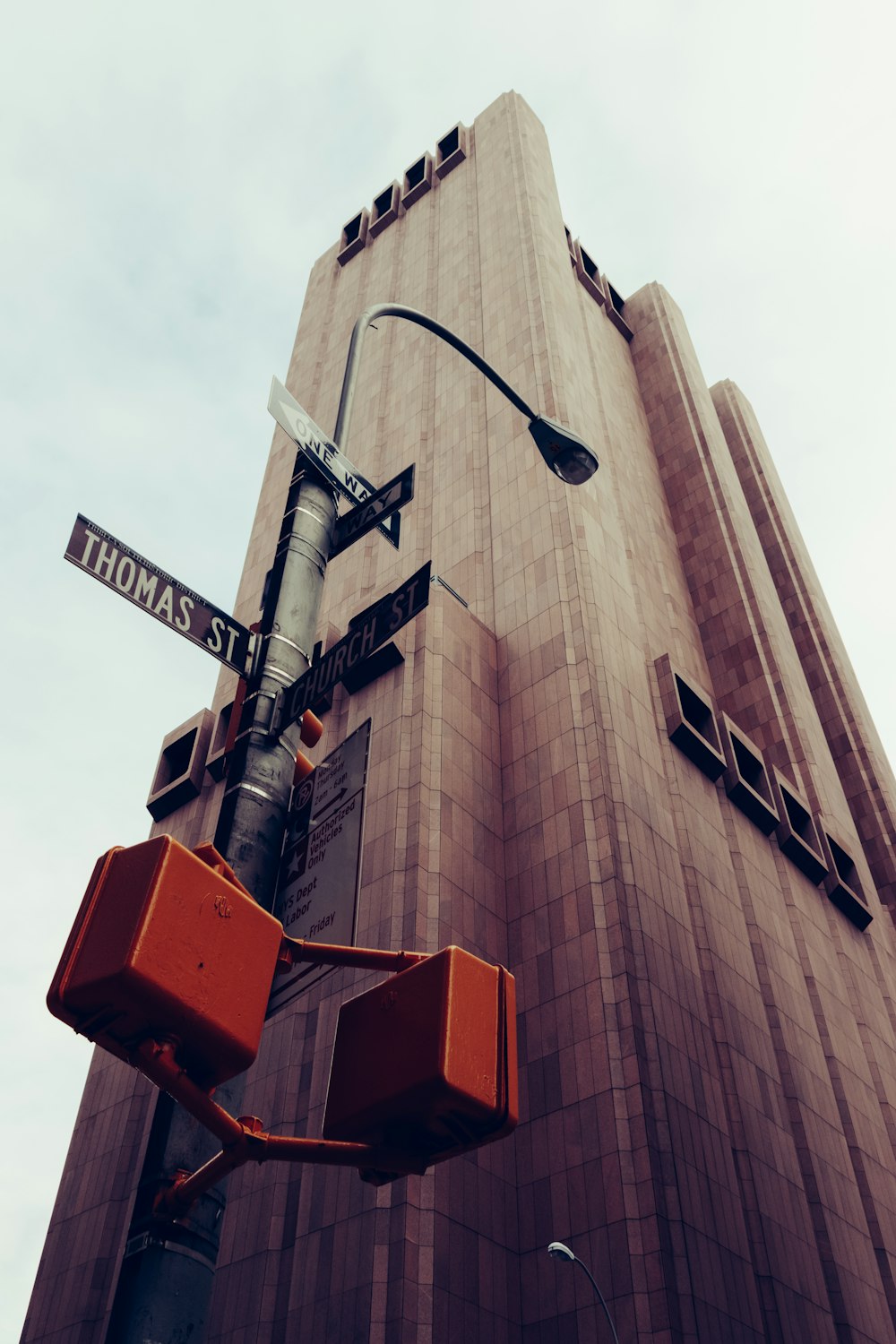 low-angle photography of Thomas St. sign