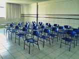 Rows of ergonomic chairs and desks arranged neatly in a classroom.