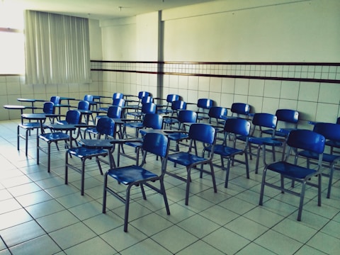 Rows of ergonomic chairs and desks arranged neatly in a classroom.