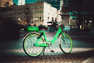 A vibrant electric bike parked near a bustling Chennai street in Mylapore.
