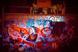 A vibrant street mural blending black, white, and red tones with abstract shapes.
