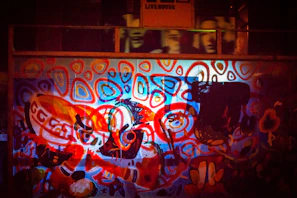 A vibrant street mural blending black, white, and red tones with abstract shapes.