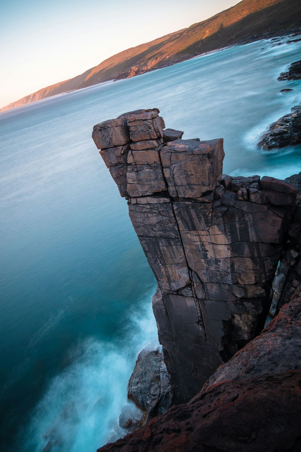 aerial photography of cliff and body of water