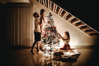 Family decorating Christmas Tree