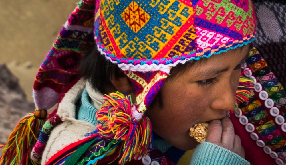 girl wearing multi-colored hat