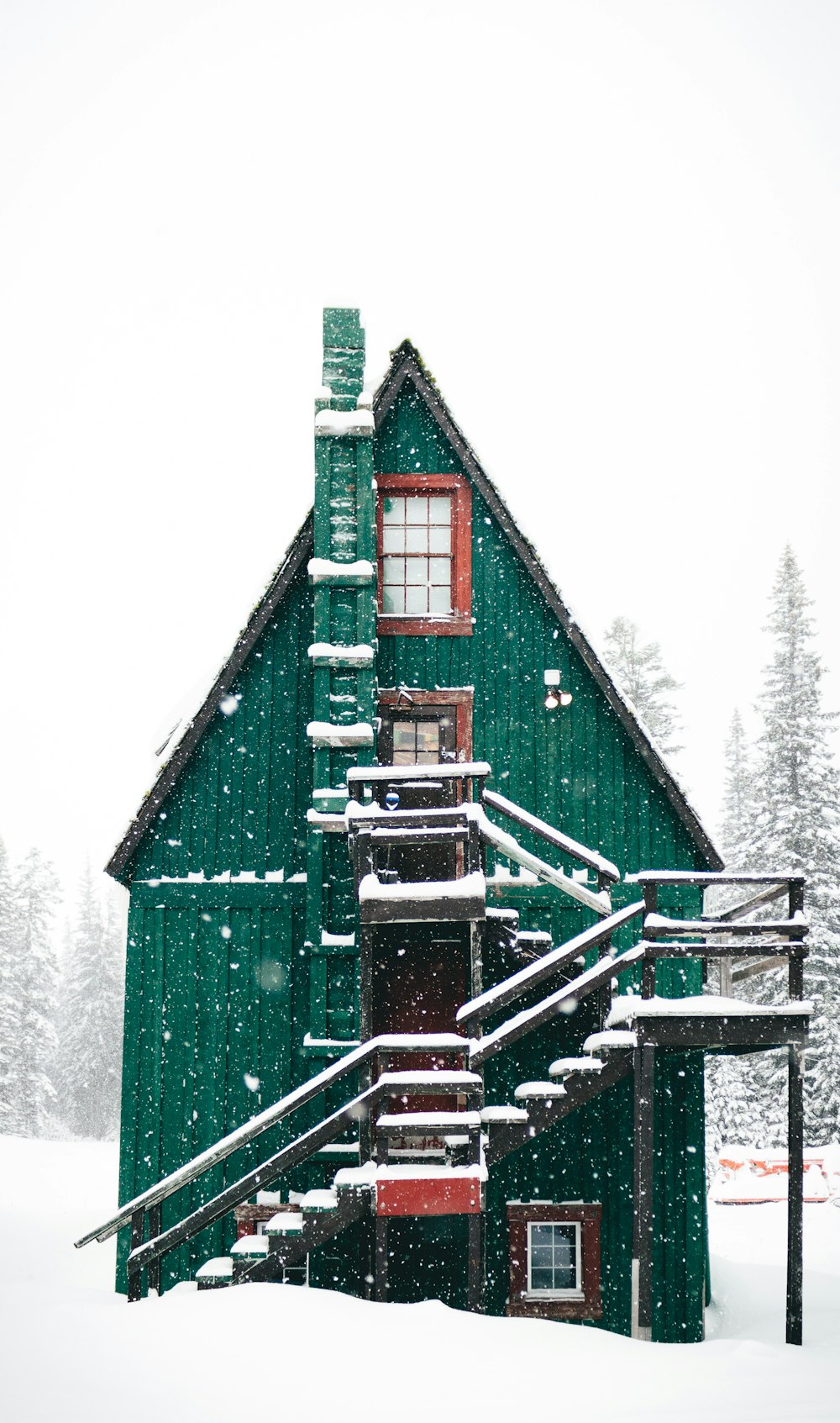 Fotografia time-lapse della neve che cade sulla casa di legno verde