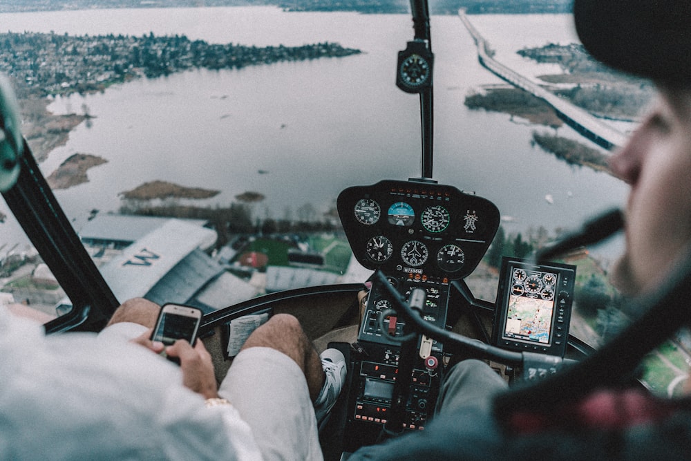 two persons riding helicopter