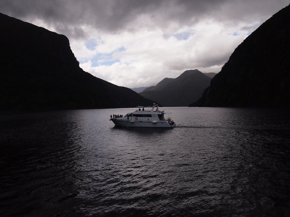 white yacht on body of water