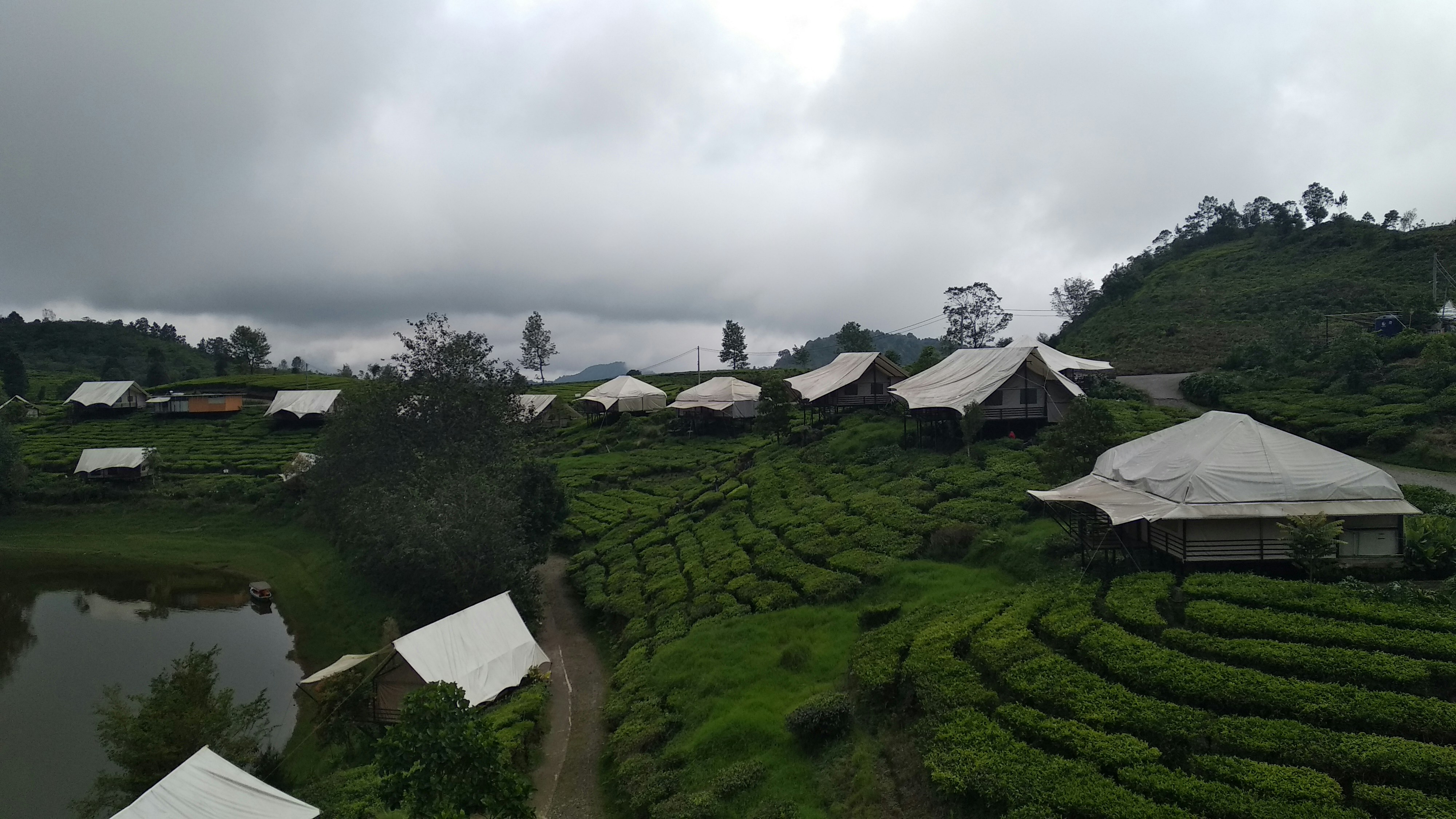 black and white houses in green field near mountain, 