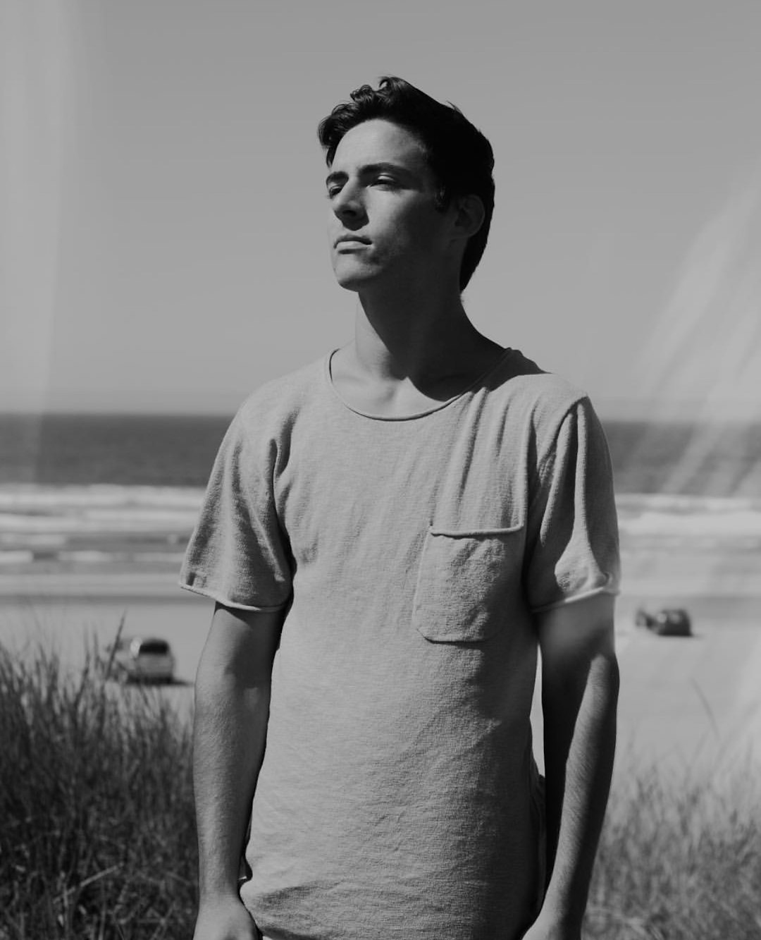 man wearing crew-neck t-shirt standing near sea