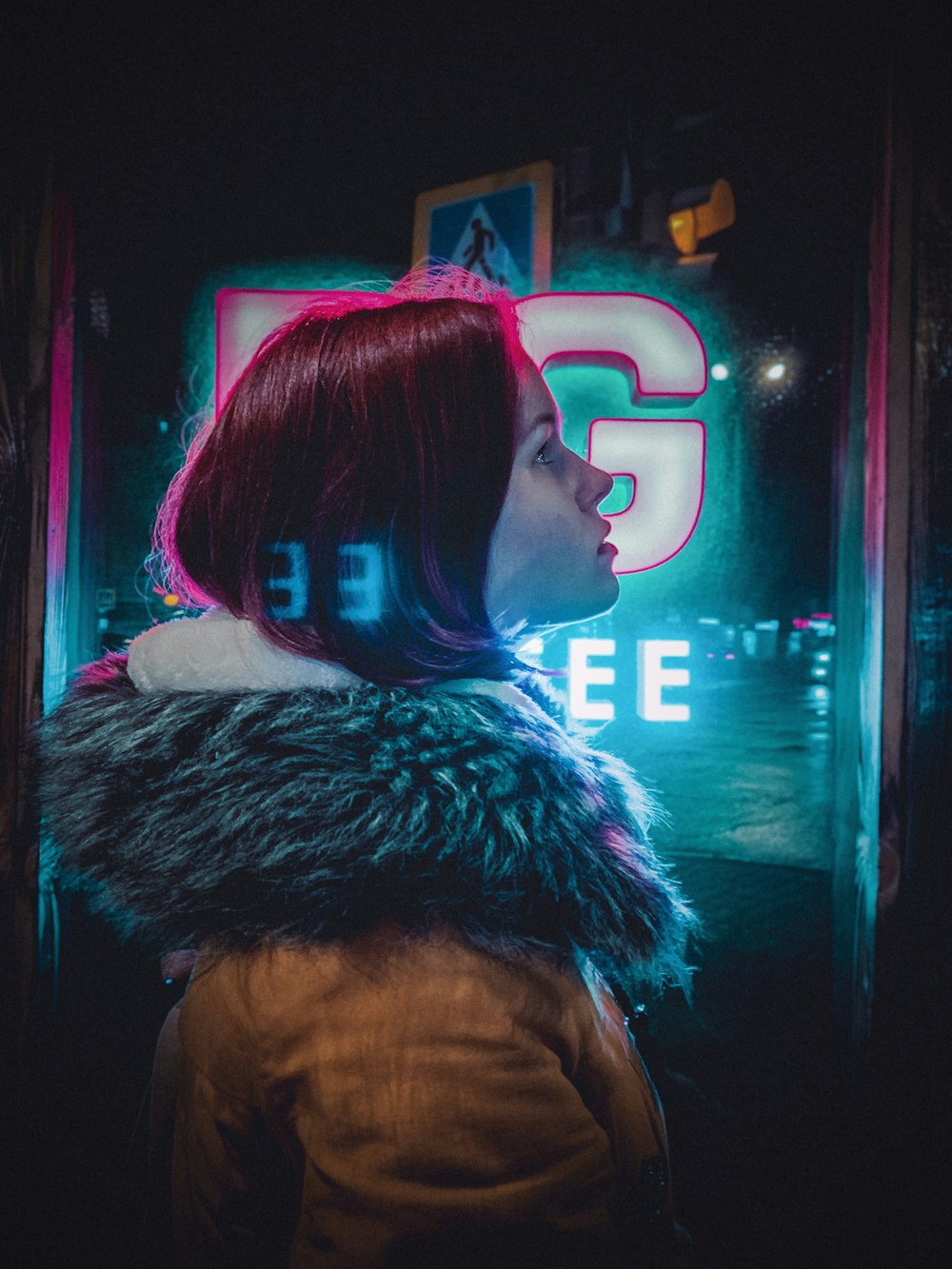 woman standing beside glass wall