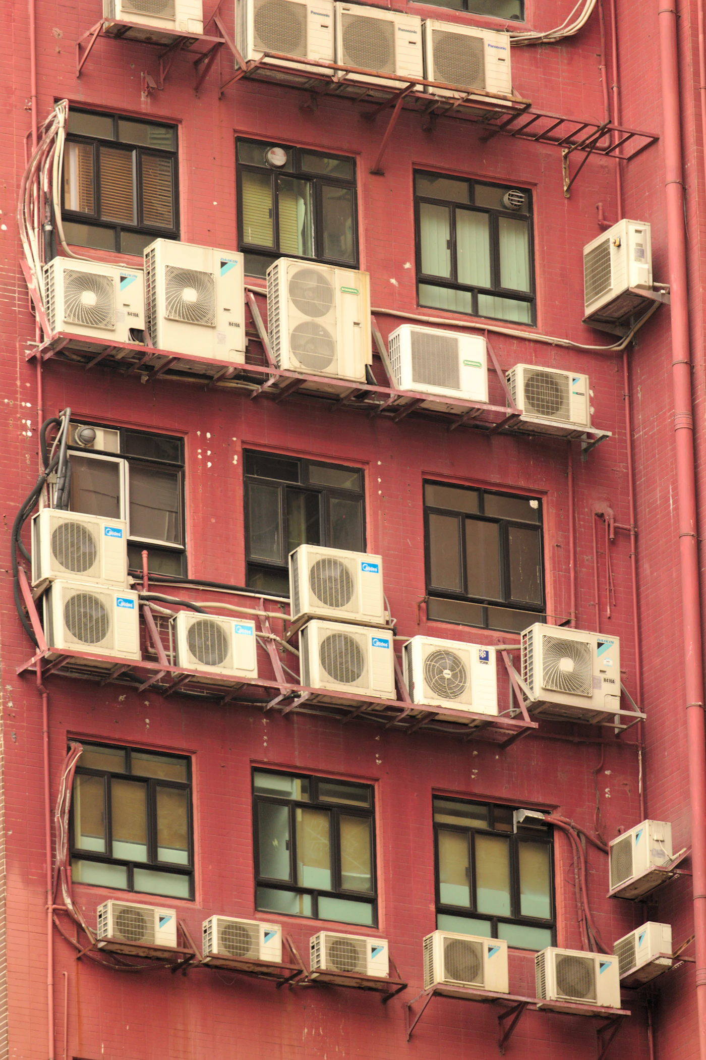 Apartment building lined with air conditioning units