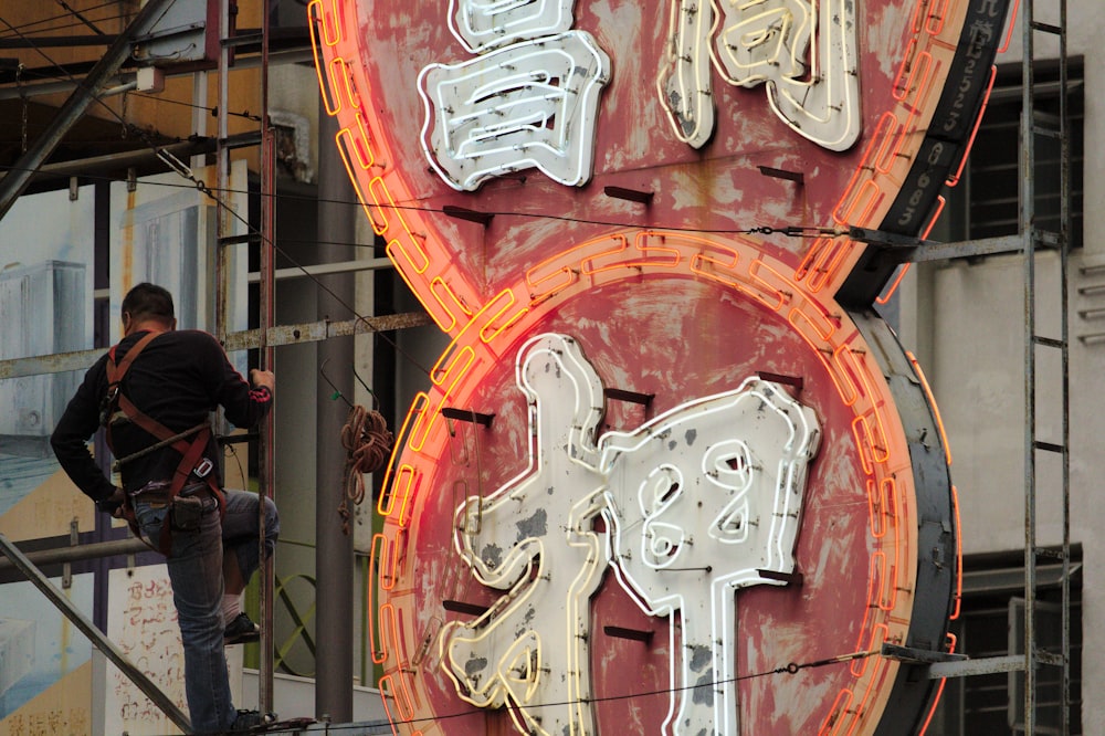 man climbing near signage