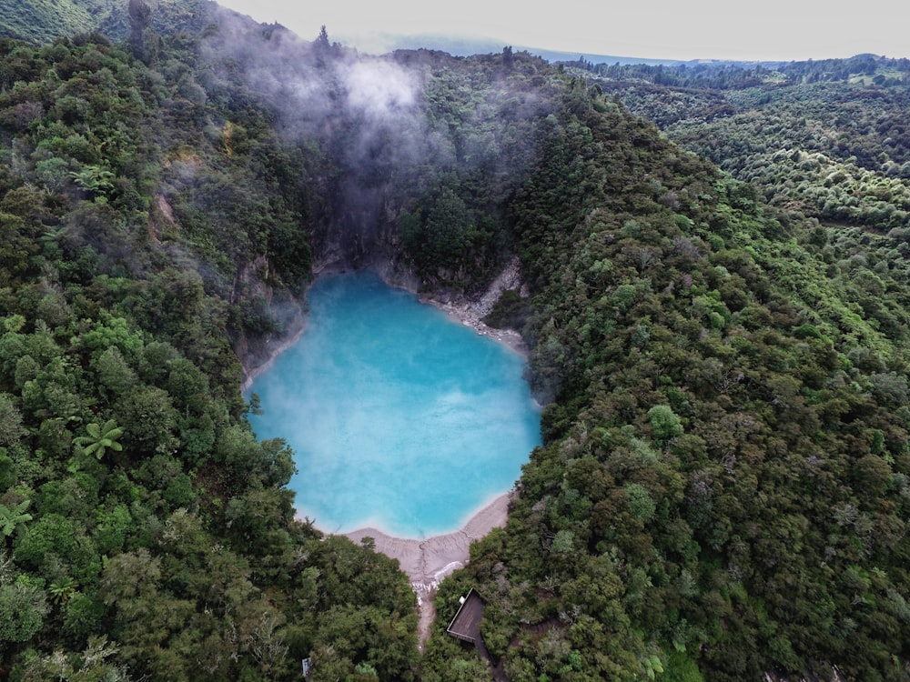 aerial photography of blue lake surrounded by green mountain