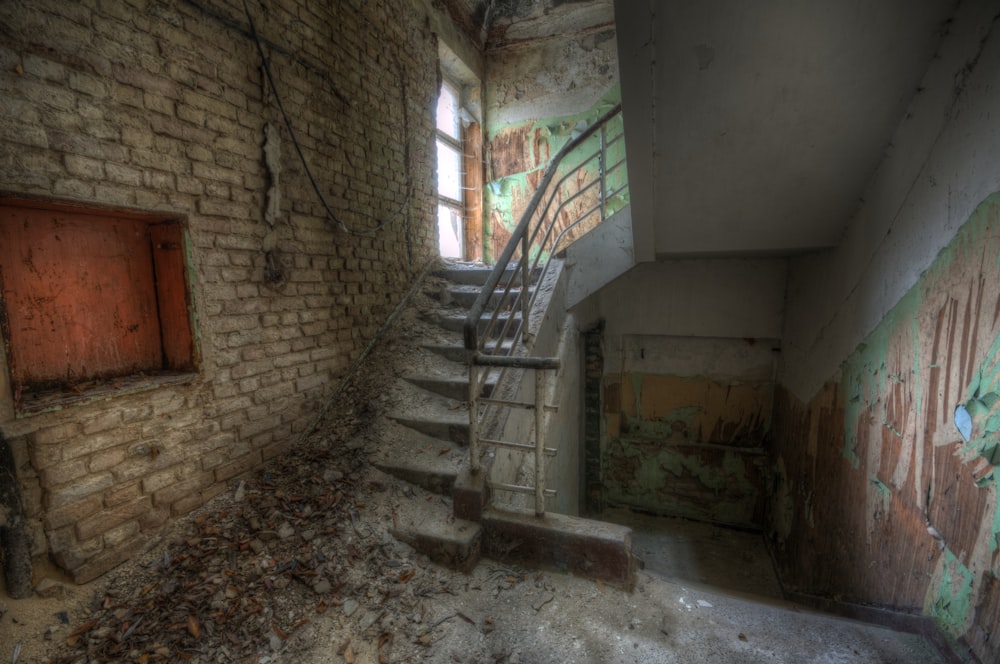 concrete staircase covered with dirt and stones