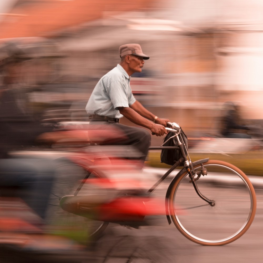 man riding black commuter bike