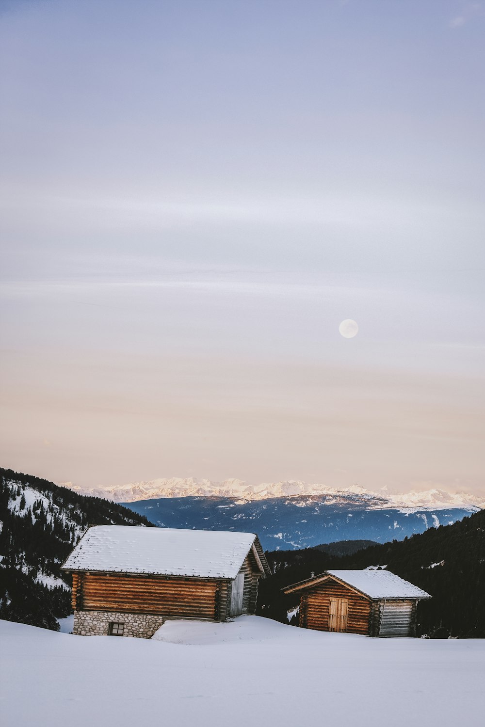 snow covered wooden houses and ground