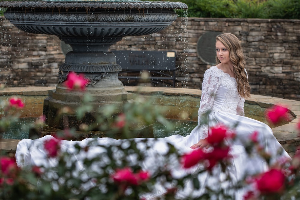 woman sitting near the fountain