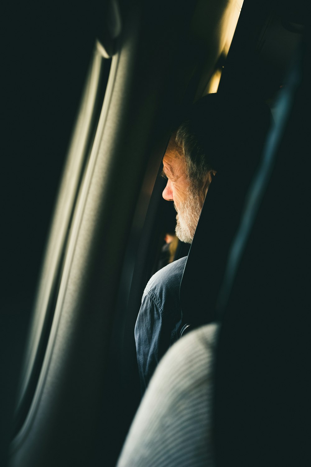 man sitting on airplane seat