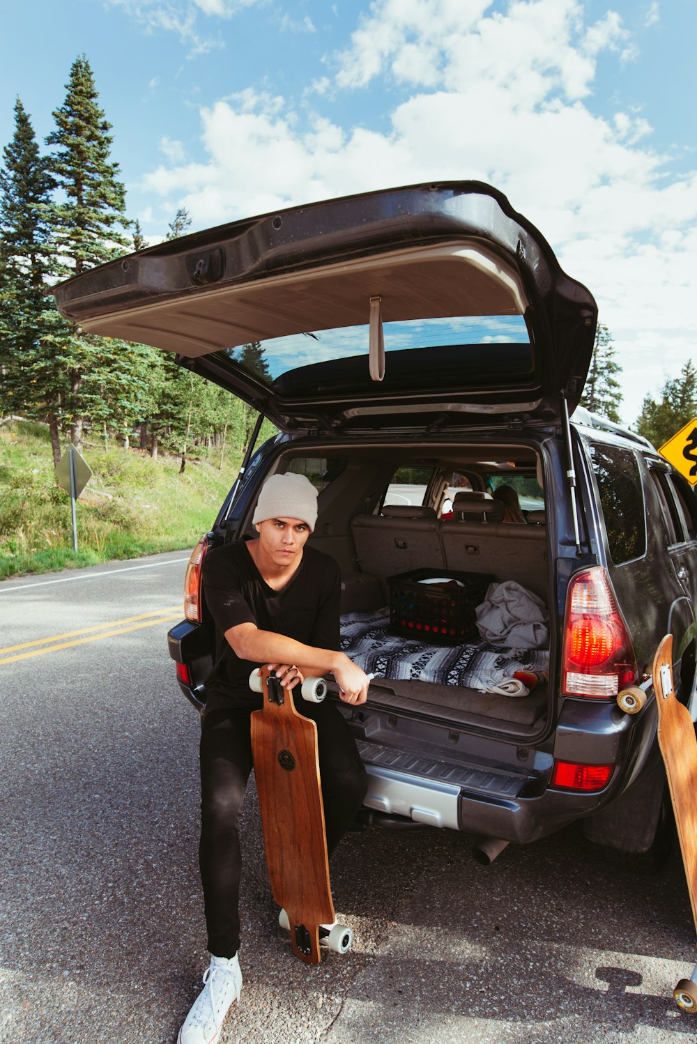 man holding brown longboard