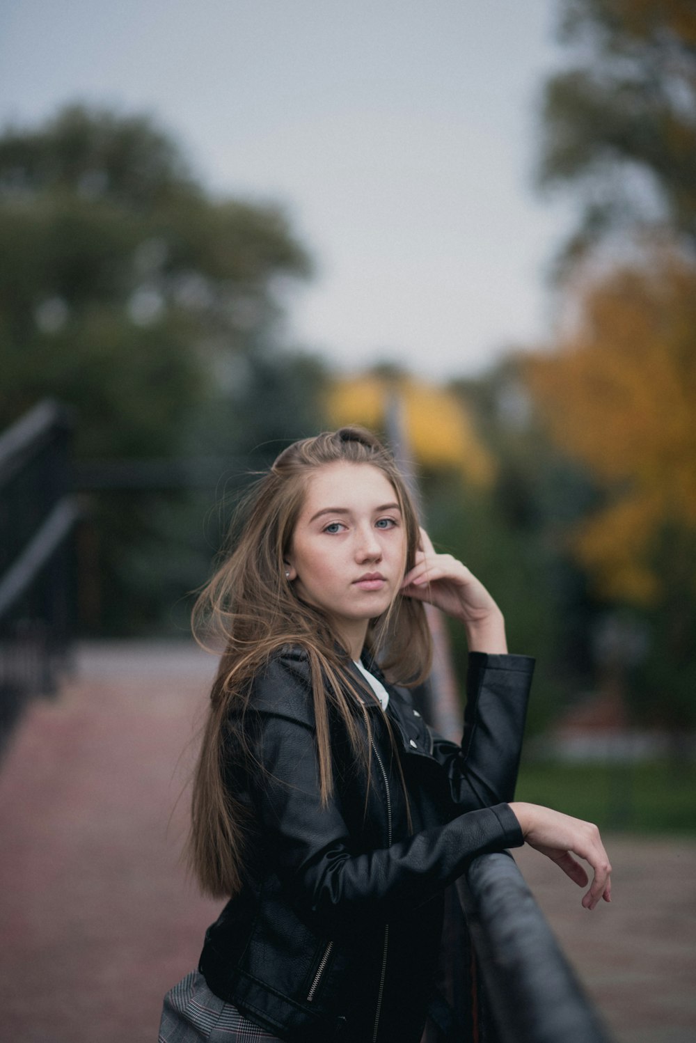 selective focus photography of woman on bridge