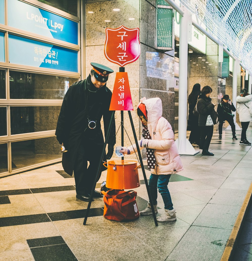 girl in white hoodie beside officer