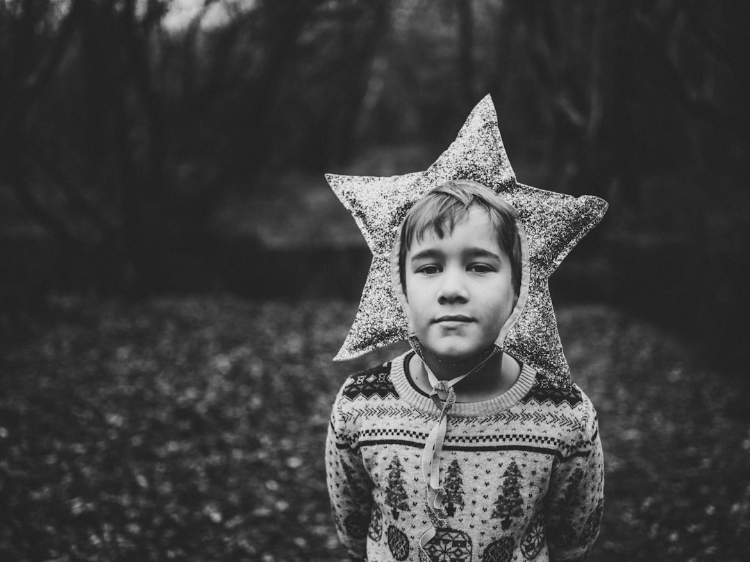 grayscale photography of boy wearing star headband