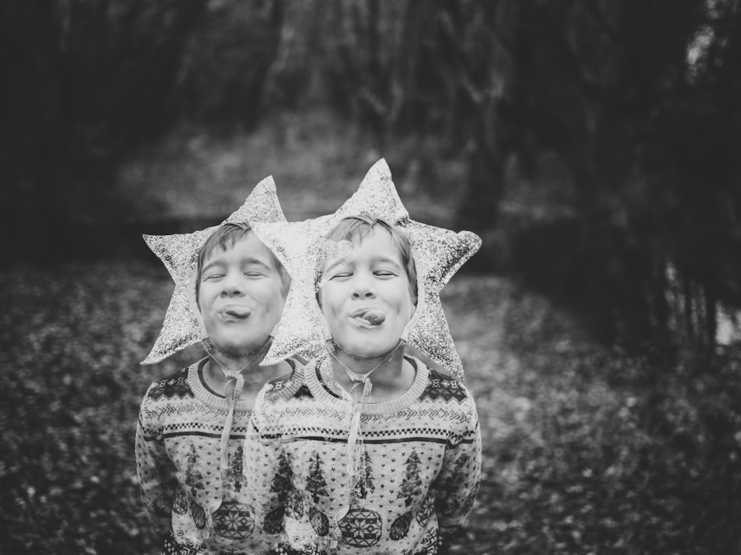 grayscale photography of two boy