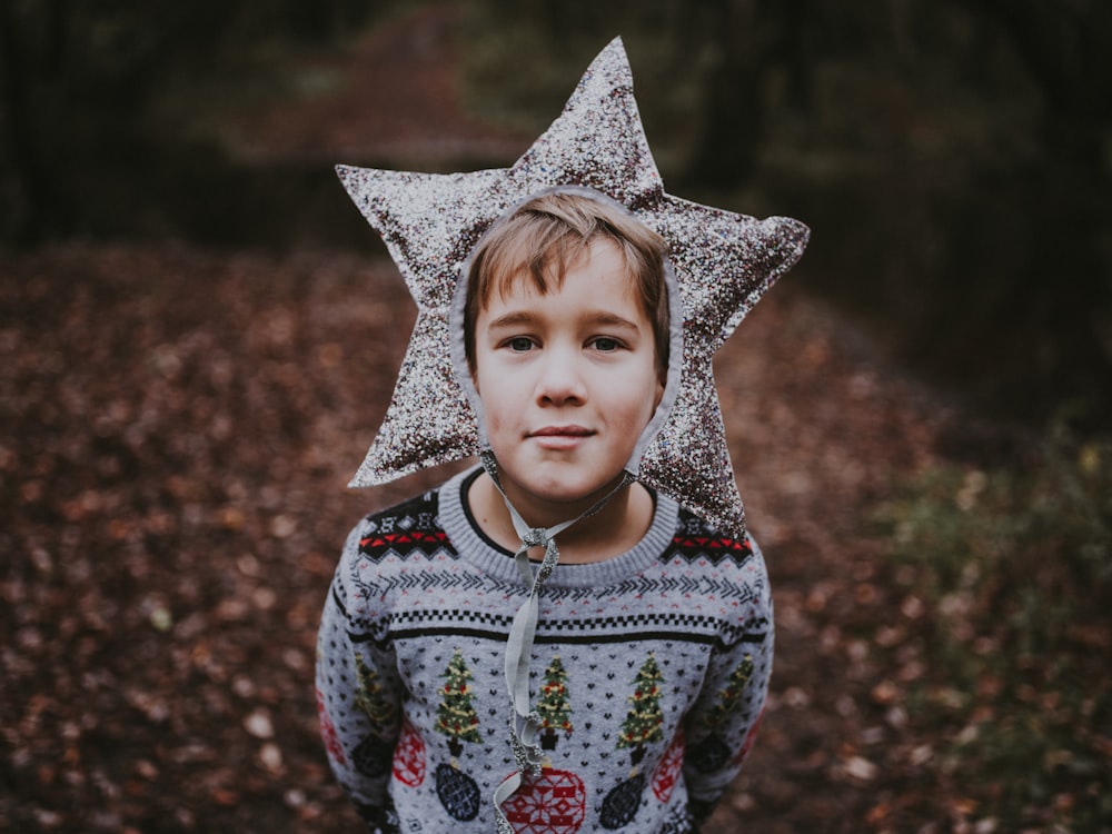 boy in sweater wearing star headdress