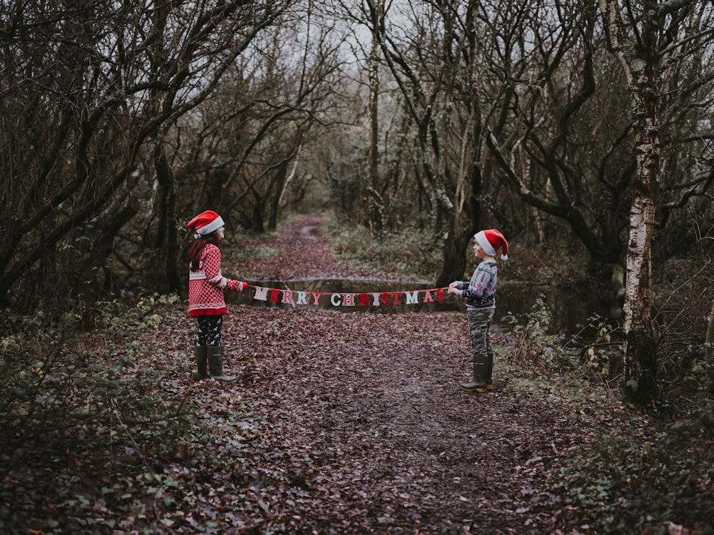 two toddlers holding Merry Christmas buntings