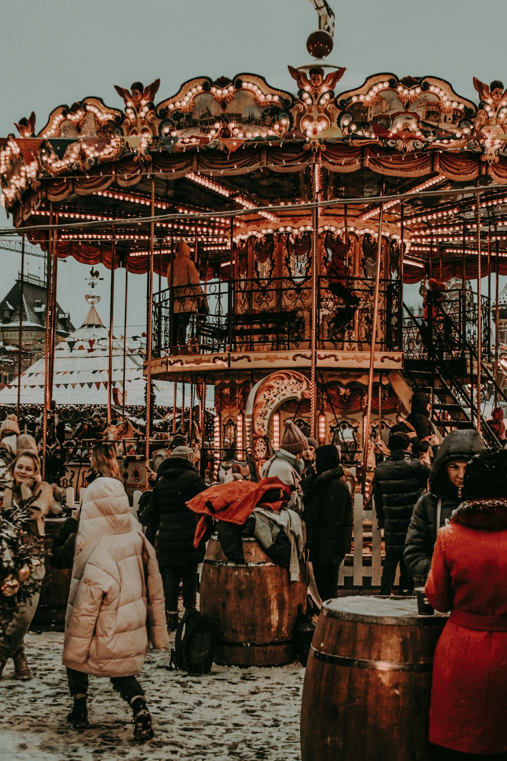 group of people standing near the carousel