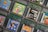 A collection of Game Boy Color cartridges is arranged in an overlapping pattern. The cartridges feature popular titles like Toy Story Racer, Power Rangers Time Force, F1 World Grand Prix, and Harry Potter. Each cartridge showcases its distinct cover art, emphasizing the diversity of games from different genres, including racing, adventure, and fantasy.