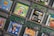 A collection of Game Boy Color cartridges is arranged in an overlapping pattern. The cartridges feature popular titles like Toy Story Racer, Power Rangers Time Force, F1 World Grand Prix, and Harry Potter. Each cartridge showcases its distinct cover art, emphasizing the diversity of games from different genres, including racing, adventure, and fantasy.