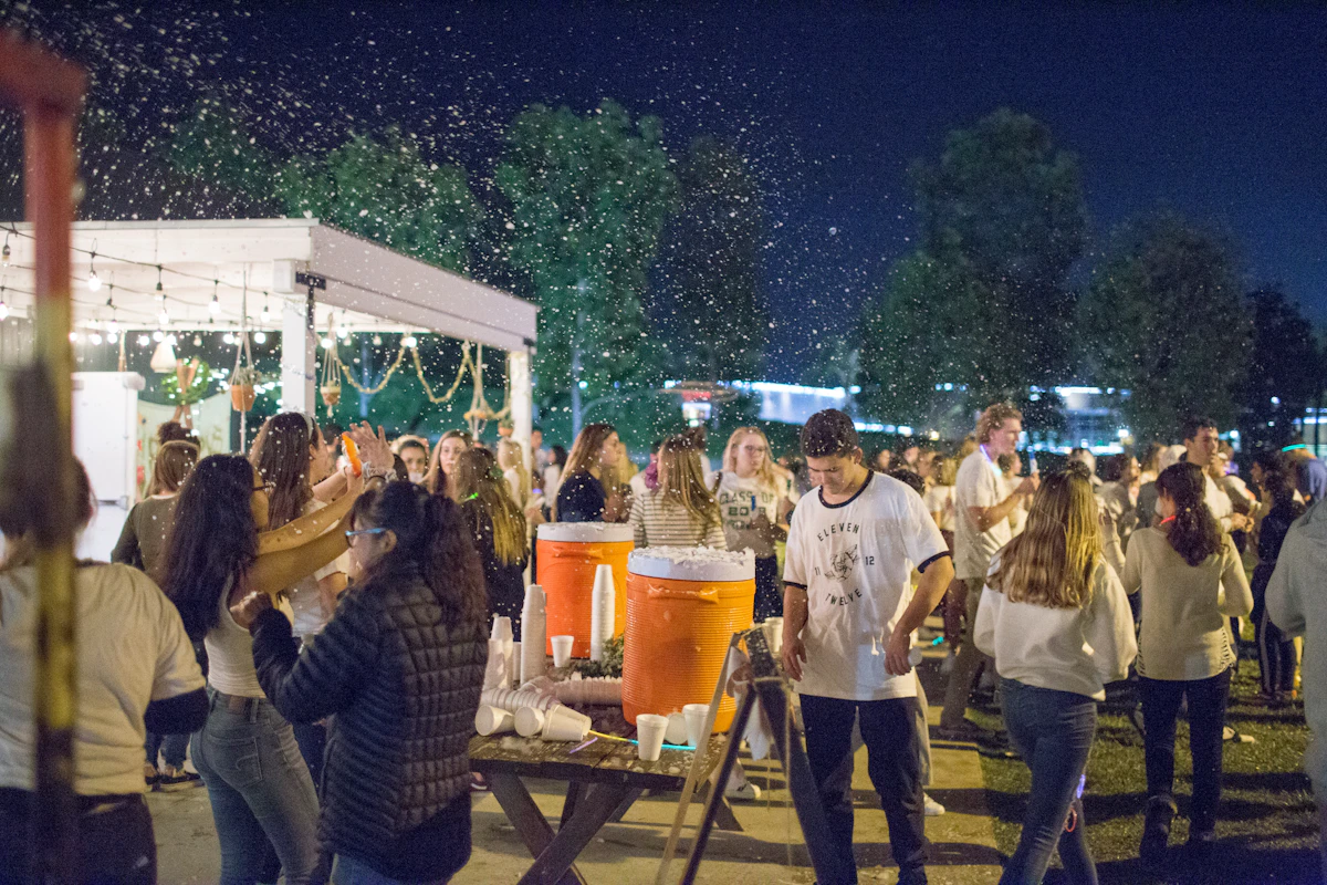 Crowds filling a festive beer tent decorated with banners and lights during a German beer festival