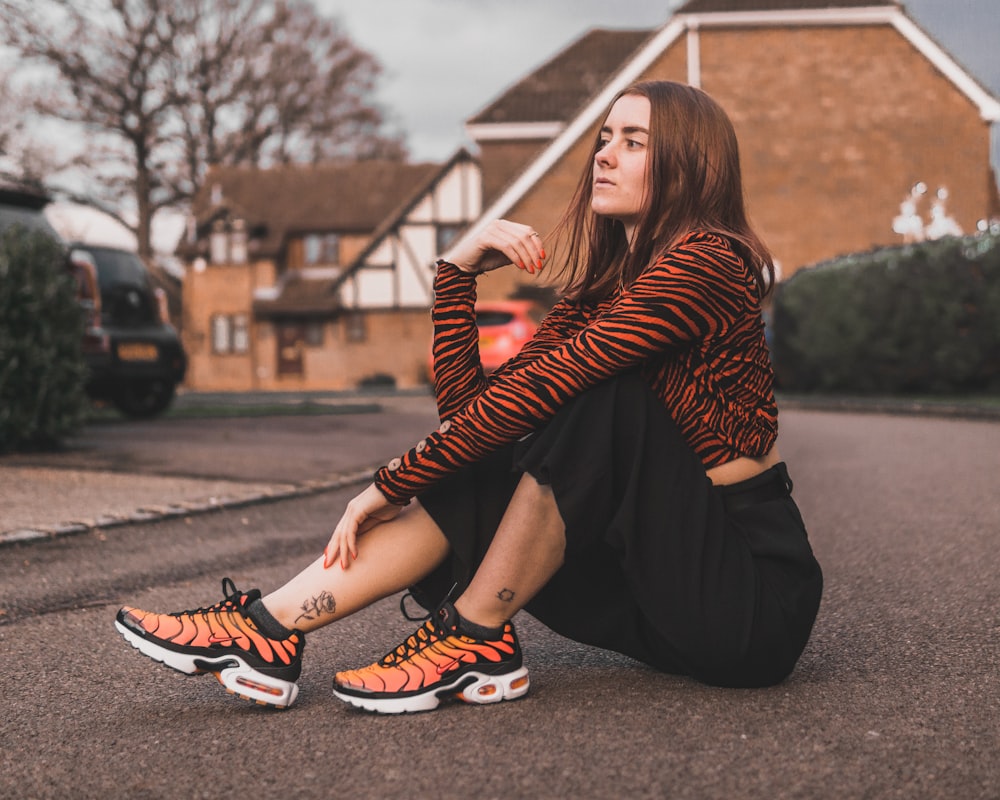 woman sitting on concrete