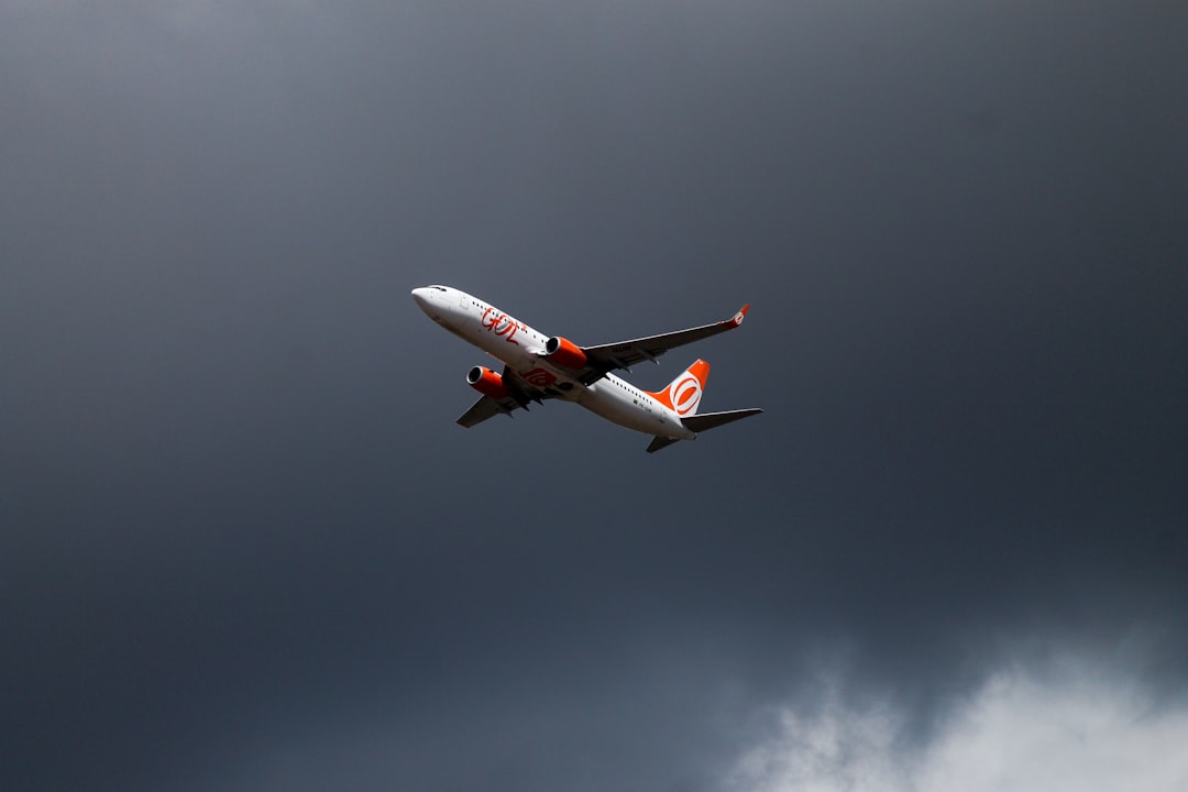 orange and white airliner on flight,