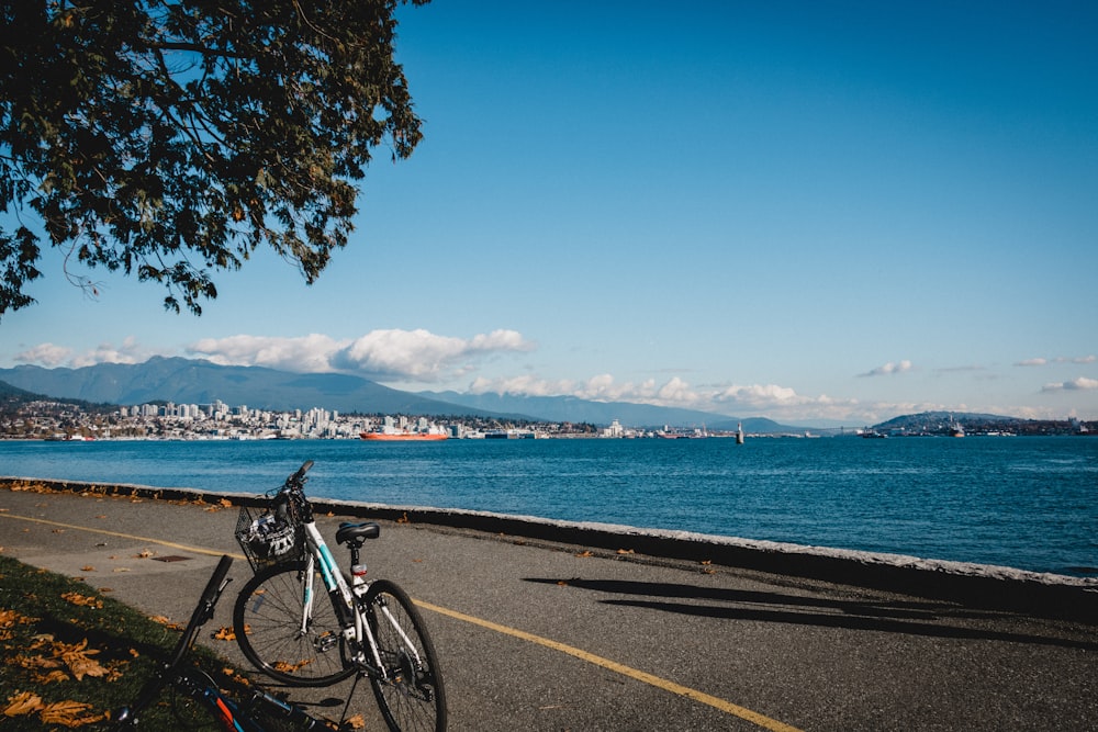 white hardtail mountain bike beside beach at daytime