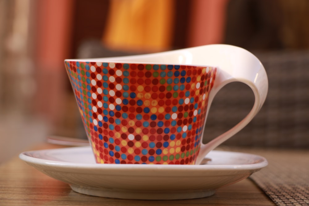 red and white cup and saucer