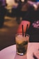 clear drinking glass with two straws