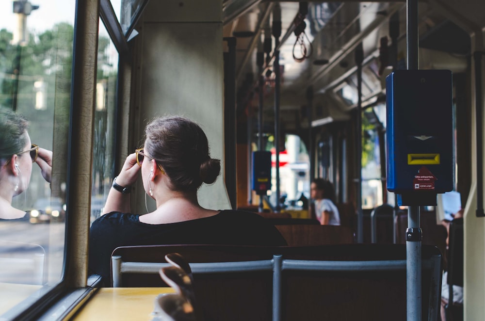 woman sitting beside window