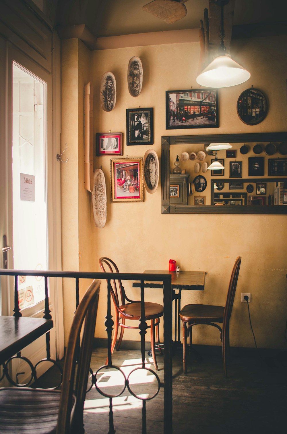 empty tables and chair near wall with photo frames